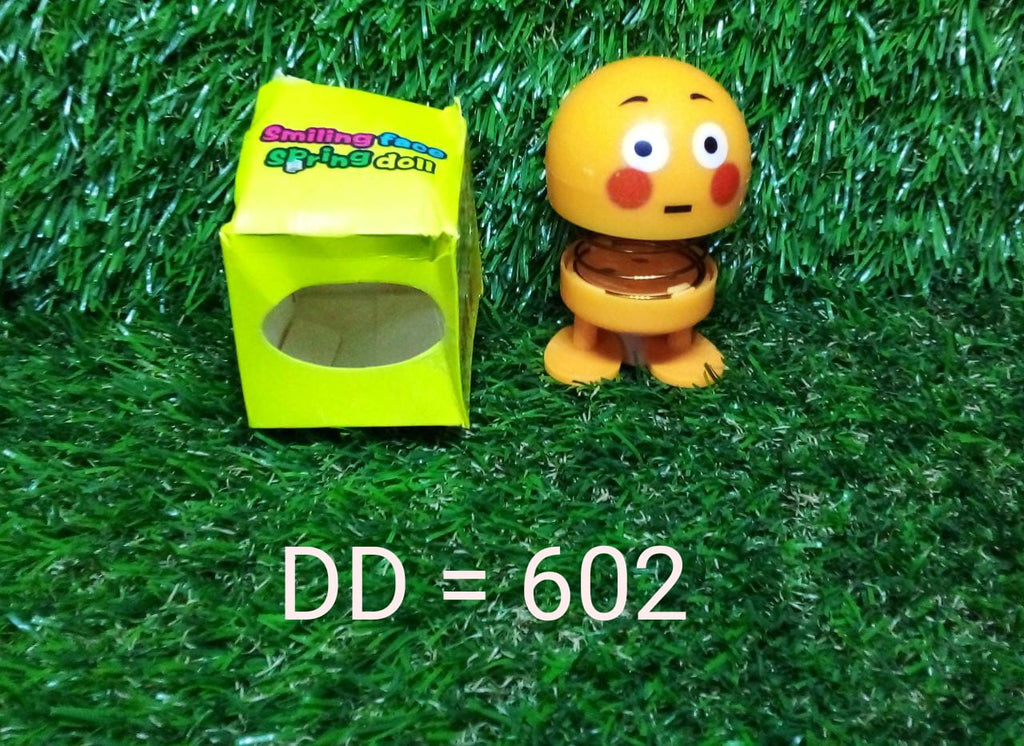 Smiling face spring figure toy with its adhesive base visible, ready for secure placement.