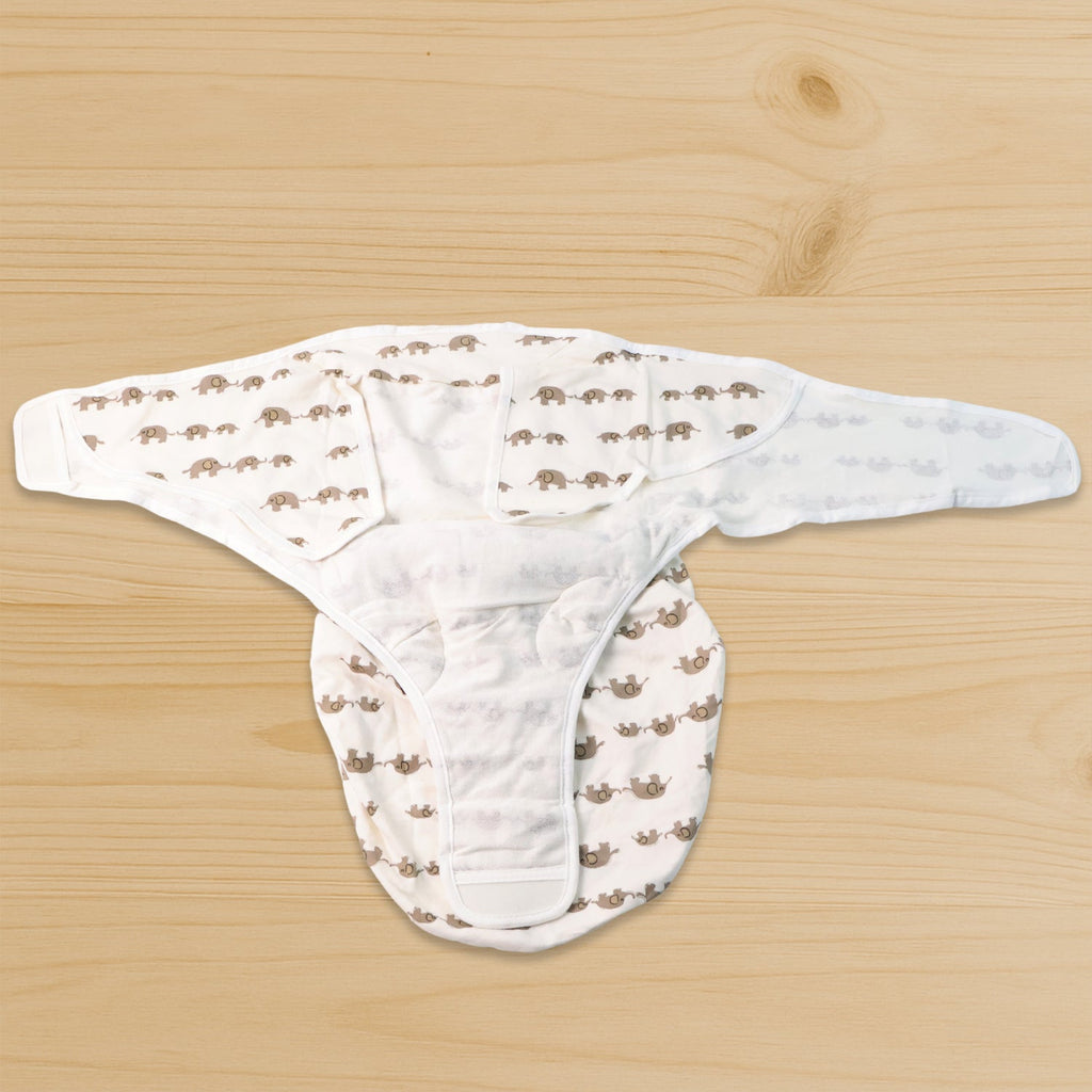 Adjustable infant swaddling wrap secured with Velcro wings