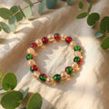 Multicolor glossy bead stretch bracelet showcasing vibrant red, green and golden beads