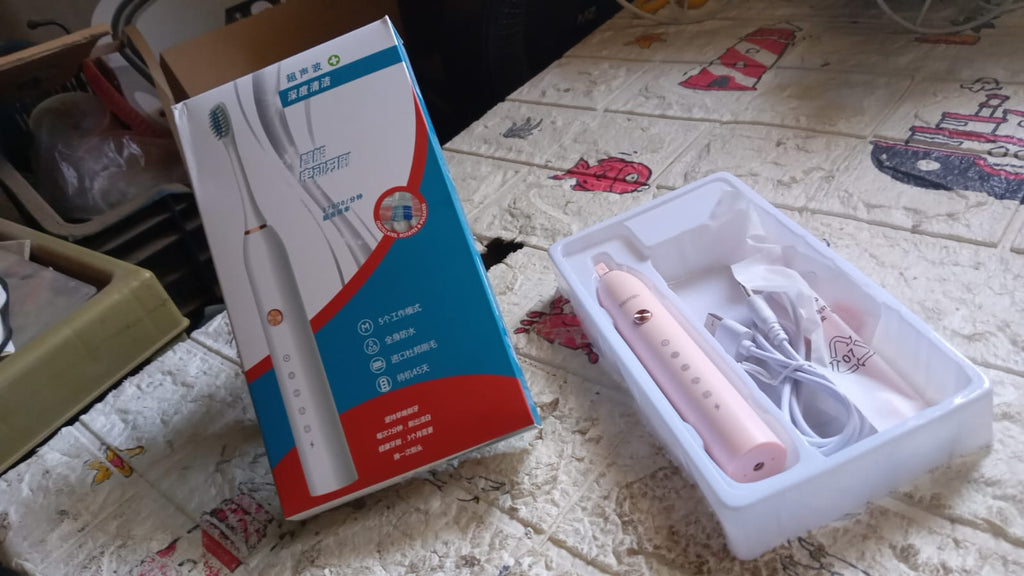 Detailed view of the Electric Toothbrush head, showing bristles and tongue cleaner.