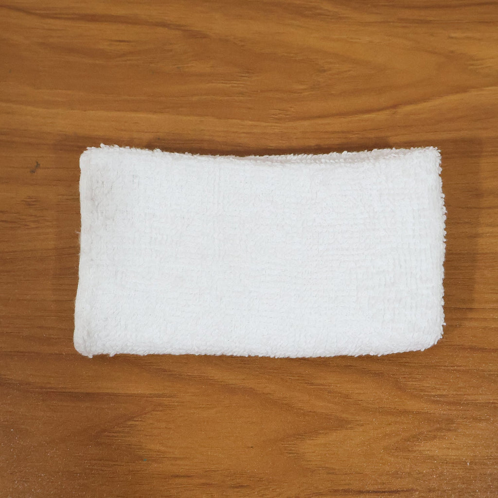 Person cleaning wooden furniture surface with microfiber cloth