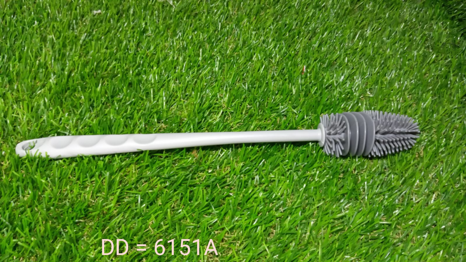 A bottle cleaning brush shown cleaning a narrow-necked bottle with ease.