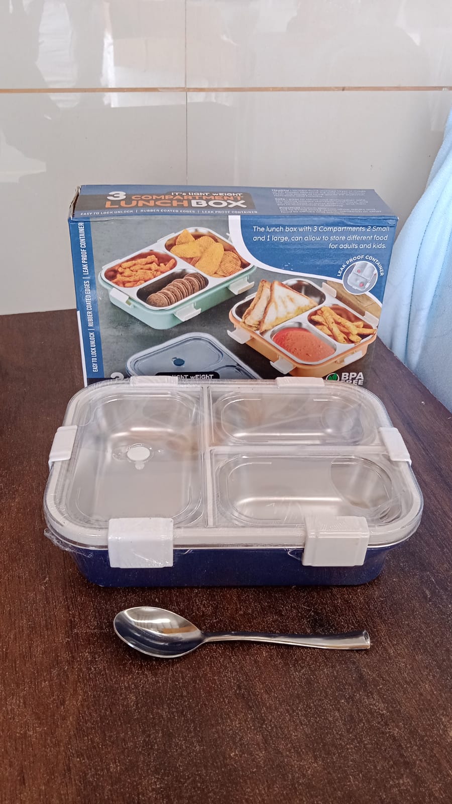 Side view of the compact 3-compartment lunch box, ideal for storage.
