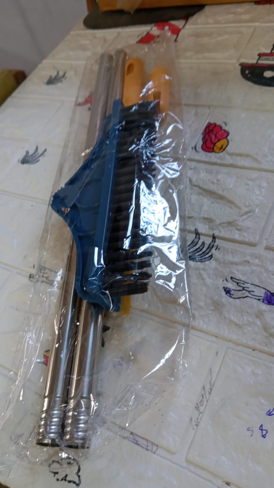 The 2-in-1 long handle cleaning brush efficiently cleaning a bathroom floor.