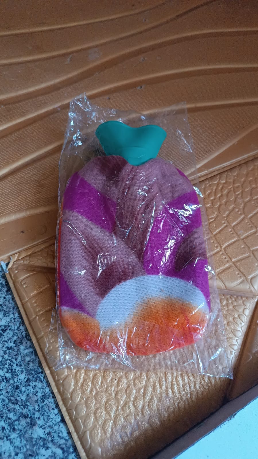 Hot water bottle bag showing durable rubber and protective soft cover