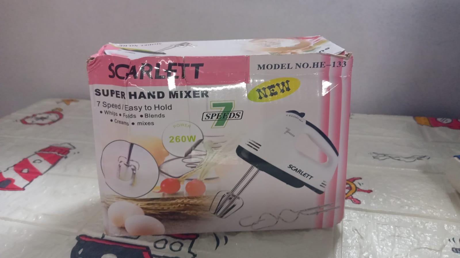 XcelCraft electric hand mixer with all attachments and product packaging.