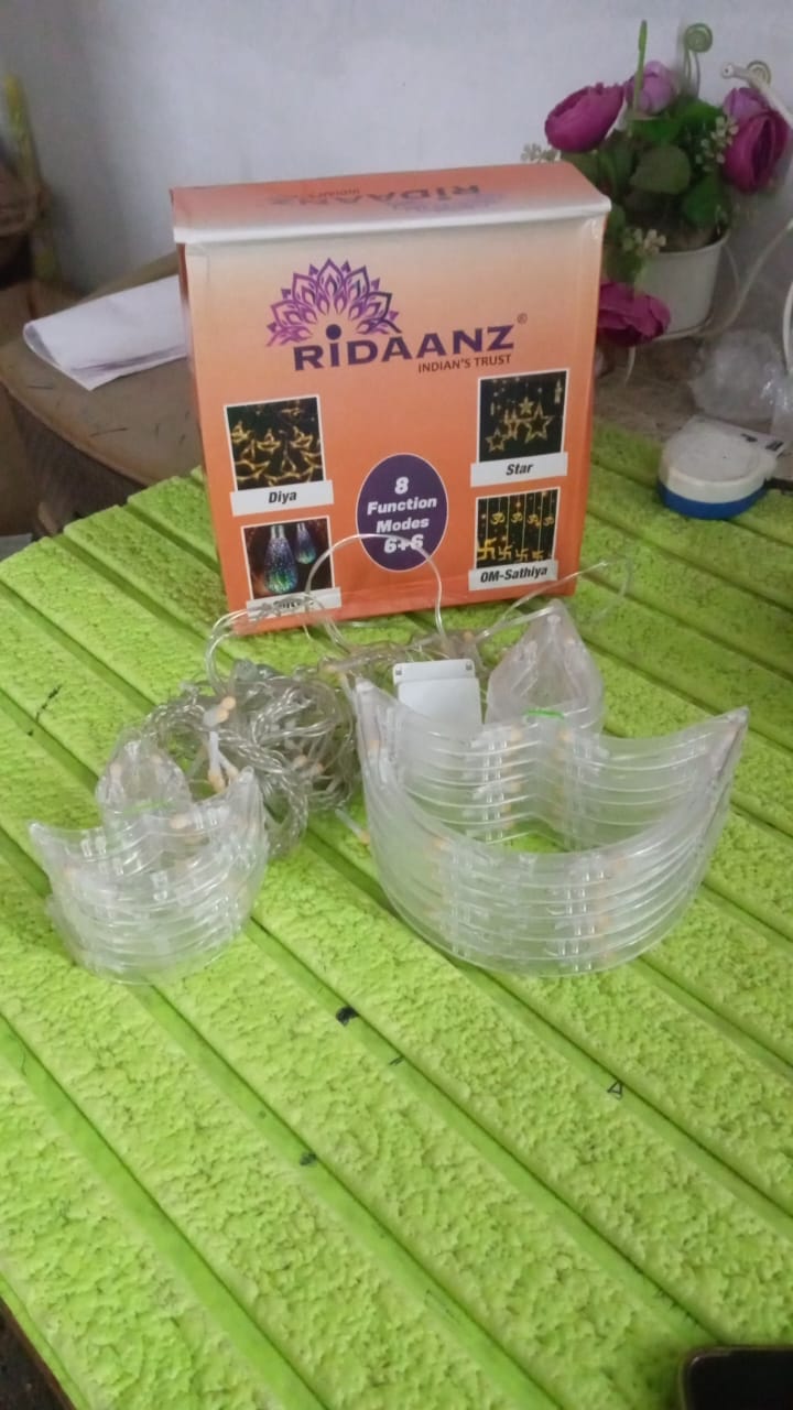 Packaging for the Indo Glow 12 Diya Curtain String Lights.