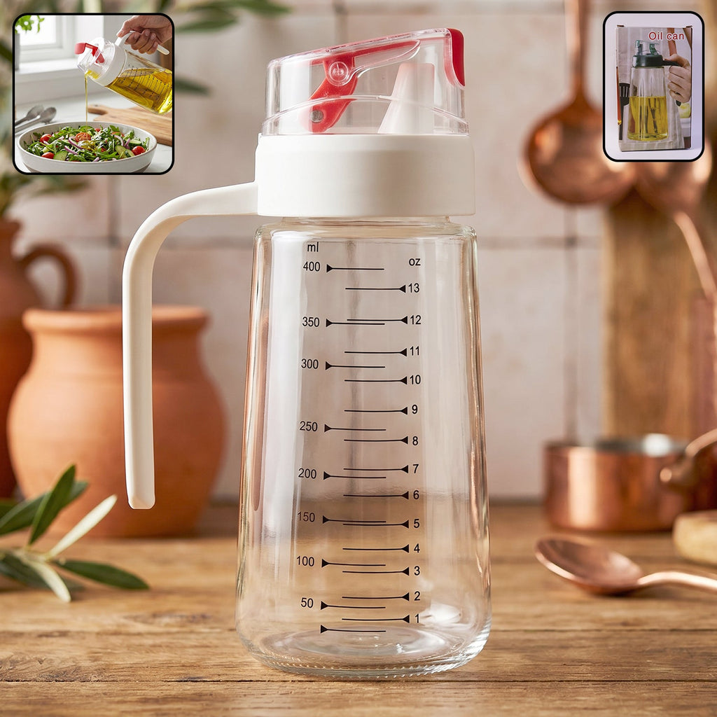 Close-up of glass oil dispenser bottle showing pouring action and side handle