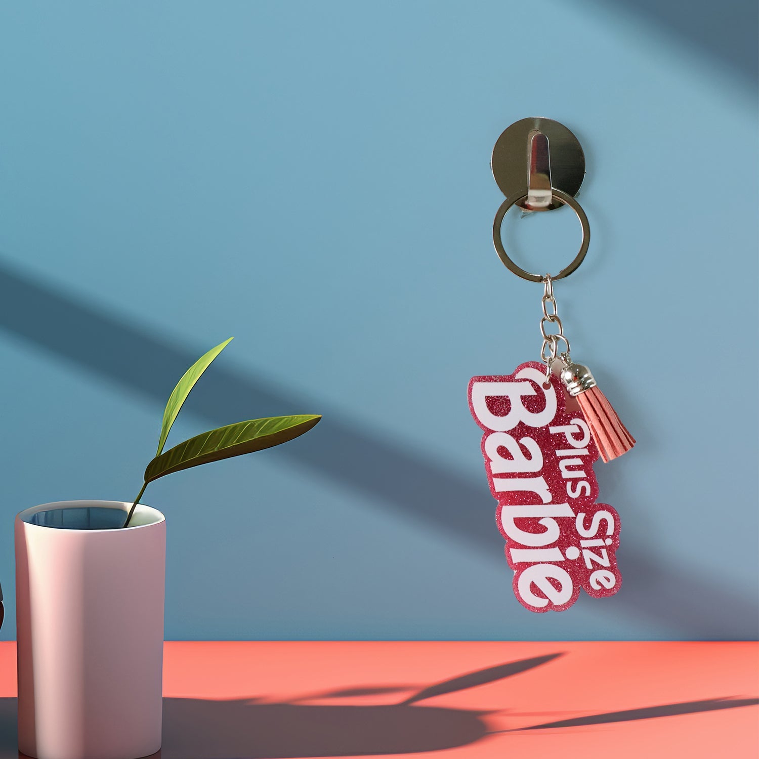 Glitter finished keychain showing Plus Size Barbie text and tassel charm