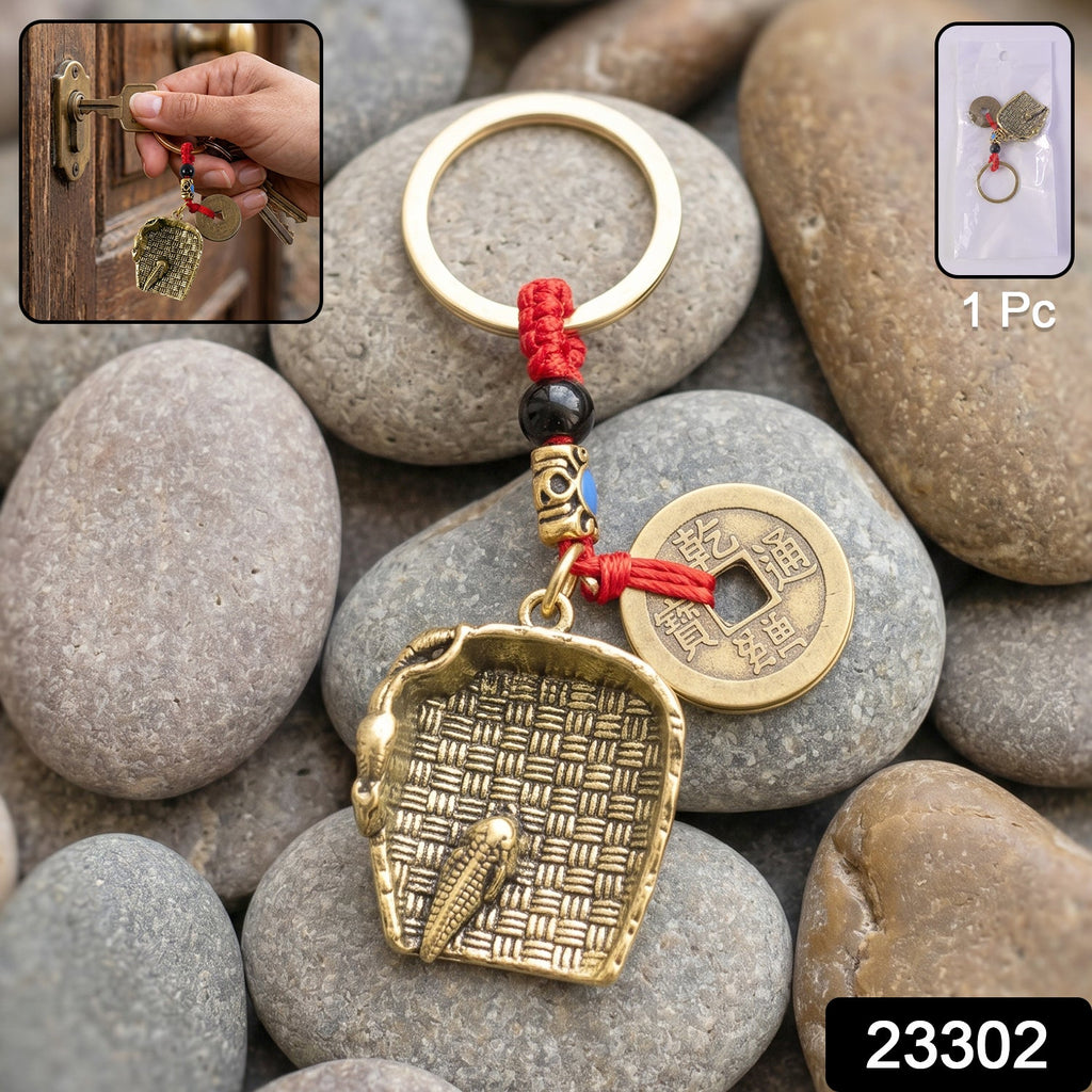 Decorative dustpan keychain charm showcasing Feng Shui symbolism
